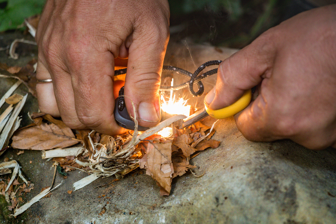 tourist man striking fire with the flint and steel